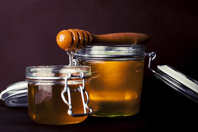 2 clear jars of honey