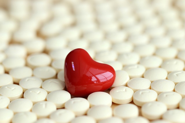 red heart pill in a sea of white pills