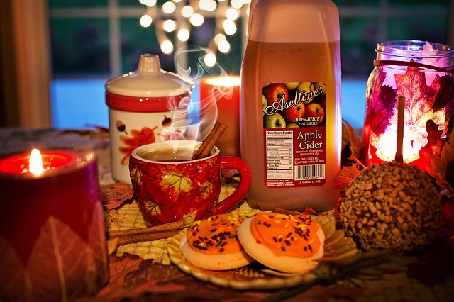 Apple cider vinegar and candles on a table